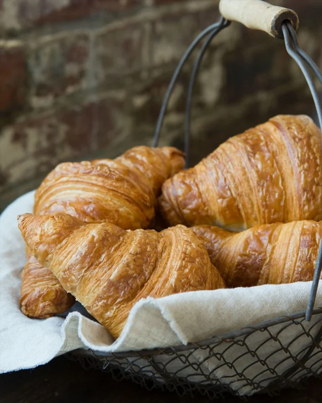 Though National Croissant day was technically on January 30th, we’re going to give it the entire weekend to celebrate and exalt.

They look simple.
They are not.

A croissant is butter + dough + patience + science.

Paper-thin layers of dough and butter are folded again and again. The alchemy happens in the oven, where heat turns moisture into steam. Trapped between those layers, the steam expands, lifting the dough up and apart instead of letting it escape.

That’s the flake.

Tender, stretchy, honeycombed on the inside.

Somehow, light and indulgent at the same time.

They can’t be rushed. They don’t forgive shortcuts.

Always worth the mess.