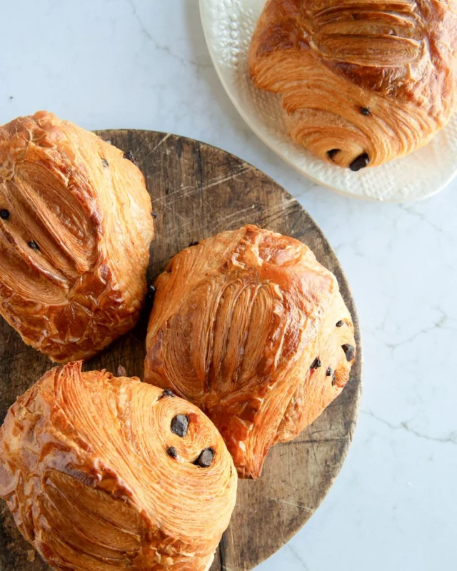 What a weird, Friday the 13th day in the PNW! We think it’s a day that calls for warm hugs and comfort food. Even better, comfort food that feels like a warm hug.

Buttery layers of croissant dough wrapped around house-made chocolate batons and chopped chocolate, baked until the outside shatters and the inside melts into something soft and deeply satisfying.

If layered buttery flakey pastry and chocolate doesn’t warm your soul, we don’t know what would.

Take that “Unexpected March Snow Day”!