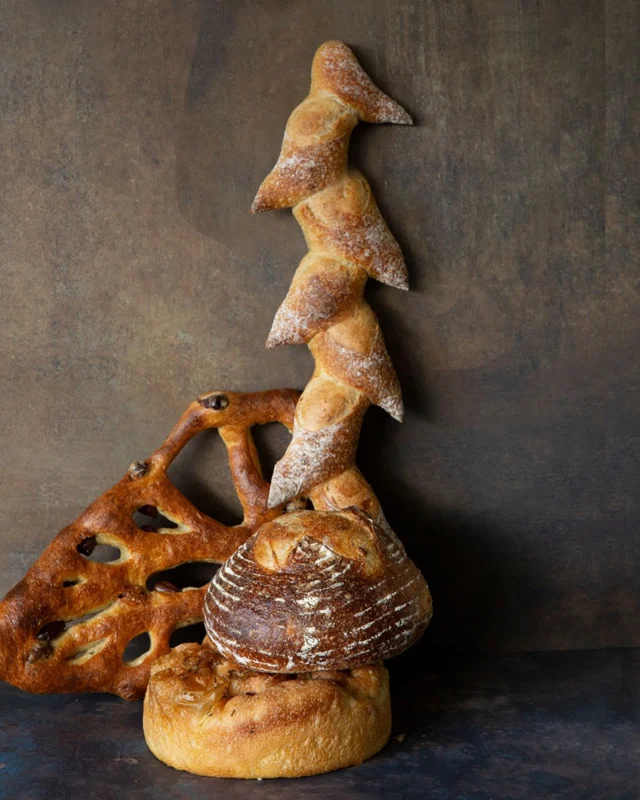 The most delicious still life you’ve ever eaten.
Bread as composition.
Bread as texture.
Bread as art.

We call it “Vertical Épi Cross-Sectioning Olive Fougasse Standing on Focaccia and Rustic Sourdough.”

A meditation on height.
A study in crust.
A bold exploration of carbohydrate architecture.

We definitely recommend you start eating it from the top. Would it then be performance art?